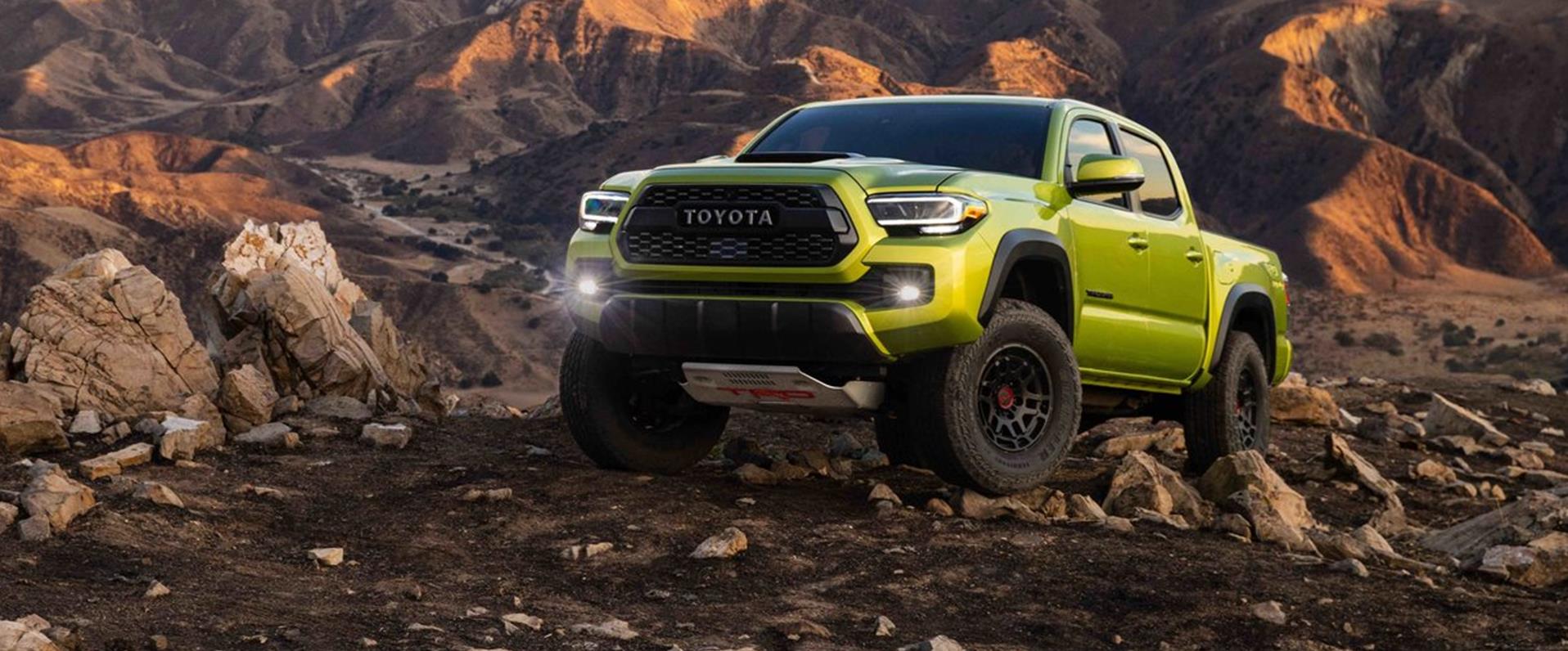 Used trucks for outdoor adventures lined up at a Michigan dealership